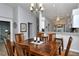 Well-lit dining area showcases a wooden table, neutral color palette, and seamless kitchen access at 5251 Mahogany Run Ave # 526, Sarasota, FL 34241