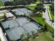 Aerial view of community tennis courts with manicured landscaping at 5251 Mahogany Run Ave # 526, Sarasota, FL 34241