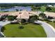 Aerial view of the main building with gorgeous green space with a putting green and beautiful landscaping at 5276 Mahogany Run Ave, Sarasota, FL 34241