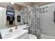 Bright bathroom featuring shower/tub combo with tiled walls, vanity, and modern shower curtain at 5276 Mahogany Run Ave, Sarasota, FL 34241