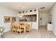 Dining room with wood floors, stylish decor and convenient pass-through to the kitchen at 5276 Mahogany Run Ave, Sarasota, FL 34241