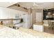 Well-lit kitchen featuring granite countertops, stainless sink, and white appliances at 5276 Mahogany Run Ave, Sarasota, FL 34241