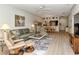 Cozy living room featuring comfortable seating, natural light and wood-look floors at 5276 Mahogany Run Ave, Sarasota, FL 34241