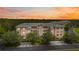 Luxury condo building with a beautiful sunset view at 5300 Manorwood Dr, Sarasota, FL 34235