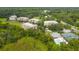 An aerial view showing the community's buildings, landscaping, and nearby waterways at 5300 Manorwood Dr, Sarasota, FL 34235