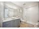 Modern bathroom with gray vanity, a walk-in shower, and marble countertops at 5300 Manorwood Dr, Sarasota, FL 34235