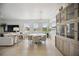 Dining room with light hardwood floors, round table and large windows at 5300 Manorwood Dr, Sarasota, FL 34235