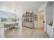 Elegant dining area with light hardwood floors and a round table at 5300 Manorwood Dr, Sarasota, FL 34235