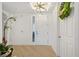 Bright and airy entryway with light hardwood floors at 5300 Manorwood Dr, Sarasota, FL 34235