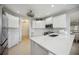 Modern kitchen with white cabinets, quartz countertops and stainless steel appliances at 5300 Manorwood Dr, Sarasota, FL 34235