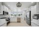 Modern kitchen with white cabinets, quartz countertops, and stainless steel appliances at 5300 Manorwood Dr, Sarasota, FL 34235