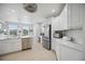 Modern kitchen with white cabinets, quartz countertops, and stainless steel appliances at 5300 Manorwood Dr, Sarasota, FL 34235