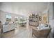 Bright living room features light hardwood floors, white couch, and a large window at 5300 Manorwood Dr, Sarasota, FL 34235