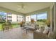 Relaxing screened porch with wicker furniture, creating an outdoor oasis at 5300 Manorwood Dr, Sarasota, FL 34235