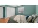 This bedroom features bright teal walls, wood floors, a window, and a double door closet at 5400 34Th W St # A17, Bradenton, FL 34210