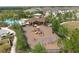 Aerial view of a community playground, swimming pool, and picnic area, with surrounding homes at 5580 Pleasantview Ct, Lakewood Ranch, FL 34211