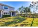 Picturesque backyard featuring a screened porch, lush lawn, and mature trees at 5580 Pleasantview Ct, Lakewood Ranch, FL 34211