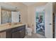 View of the bathroom with granite countertops and a view to the bedroom at 5580 Pleasantview Ct, Lakewood Ranch, FL 34211