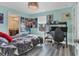 This bedroom features light blue walls, a gray floor, and a desk area for a relaxing and productive space at 5580 Pleasantview Ct, Lakewood Ranch, FL 34211