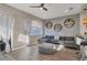 Stylish living room features hardwood floors, a comfy couch, modern decor, and a sliding door to the porch at 5580 Pleasantview Ct, Lakewood Ranch, FL 34211