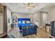 Bright main bedroom featuring a blue bed, wood floors, and tray ceiling at 5580 Pleasantview Ct, Lakewood Ranch, FL 34211