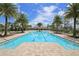 Community pool featuring in-pool palm tree island and zero-entry access at 5580 Pleasantview Ct, Lakewood Ranch, FL 34211