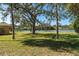 Well-maintained backyard with lake views and mature trees at 5630 Saint Louis Ave, Sarasota, FL 34233