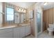 Bathroom featuring wallpaper, single sink vanity, and a walk-in shower at 5630 Saint Louis Ave, Sarasota, FL 34233