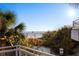 Balcony view overlooking Siesta Beach, with palm trees and lifeguard towers in the distance at 5630 Saint Louis Ave, Sarasota, FL 34233