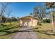 View of detached garage on property, with mature landscaping at 5630 Saint Louis Ave, Sarasota, FL 34233