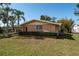 Well-maintained home featuring a lush lawn, mature trees and tropical landscaping at 5630 Saint Louis Ave, Sarasota, FL 34233