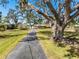 Charming single-story home with mature trees, a spacious front yard and paved driveway at 5630 Saint Louis Ave, Sarasota, FL 34233