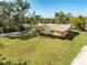 Exterior view of the house and oversized lot with mature trees at 5630 Saint Louis Ave, Sarasota, FL 34233