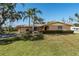 Charming single-story home with a manicured lawn and mature landscaping at 5630 Saint Louis Ave, Sarasota, FL 34233