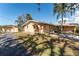 Home exterior featuring a driveway, an attached and detached garage, and yard at 5630 Saint Louis Ave, Sarasota, FL 34233