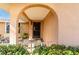 Arched front entrance featuring a secure black gate and a glimpse of a well-maintained garden at 5630 Saint Louis Ave, Sarasota, FL 34233