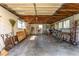 A spacious garage with exposed rafters, shelving and a workbench at 5630 Saint Louis Ave, Sarasota, FL 34233