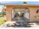 A spacious garage with an arched doorway, shelving and space for parking and storage at 5630 Saint Louis Ave, Sarasota, FL 34233