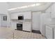 Functional kitchen featuring white cabinets, appliances, and a tiled floor at 5630 Saint Louis Ave, Sarasota, FL 34233