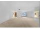 Large living room featuring neutral carpeting, chandelier and bay window at 5630 Saint Louis Ave, Sarasota, FL 34233