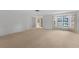 Expansive living room area featuring neutral carpeting and bay window at 5630 Saint Louis Ave, Sarasota, FL 34233