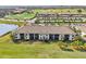 Aerial view of condo building showcasing tile roof and golf course at 5721 Palmer Cir # 205, Lakewood Ranch, FL 34211