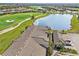 Aerial view of condo building showcasing tile roof and parking at 5721 Palmer Cir # 205, Lakewood Ranch, FL 34211