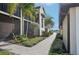 Attractive walkway leading to condo building with lush landscaping at 5721 Palmer Cir # 205, Lakewood Ranch, FL 34211