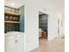 Stylish wet bar with hexagon tile and wooden shelving at 5721 Palmer Cir # 205, Lakewood Ranch, FL 34211