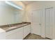 Double vanity bathroom with gray countertops and white cabinets at 5866 Bungalow Grove Ct, Palmetto, FL 34221