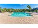 Community pool with brick patio and palm trees at 5866 Bungalow Grove Ct, Palmetto, FL 34221