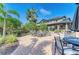 Community fire pit area with seating and palm trees at 5866 Bungalow Grove Ct, Palmetto, FL 34221