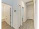 Hallway with tile flooring and access to bedrooms and bathroom at 5866 Bungalow Grove Ct, Palmetto, FL 34221