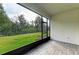 Screened porch overlooking a grassy backyard at 5866 Bungalow Grove Ct, Palmetto, FL 34221